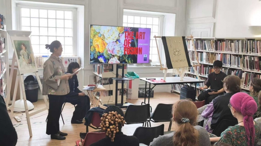 ▲Zhou Xueqing delivers a lecture at the Royal School of Needlework in the UK, Oct 9, 2025 (local time).